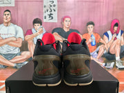 Rear view of Nike Kobe camouflage sneakers showing black collars, red accents and translucent brown-toned heel sections.