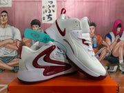 Angled view of the paired white and burgundy Nike high-top basketball sneakers with visible side branding and pull tabs.