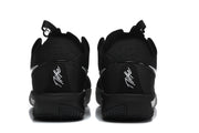 Rear view of the black Nike shoes showing heel details and pull tabs.