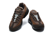 Side profile of a brown Nike Air Max 95 TT sneaker with visible air units.