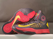 Pair of high-top basketball shoes with the circular outsole tread visible