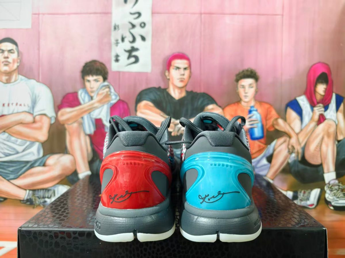 Rear view of black basketball sneakers showing contrasting red and blue heel sections and white outsoles.