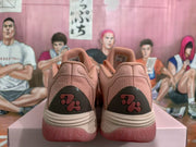 Rear view of the pink sneakers showing textured heel panels, dark heel inserts, and layered midsoles.