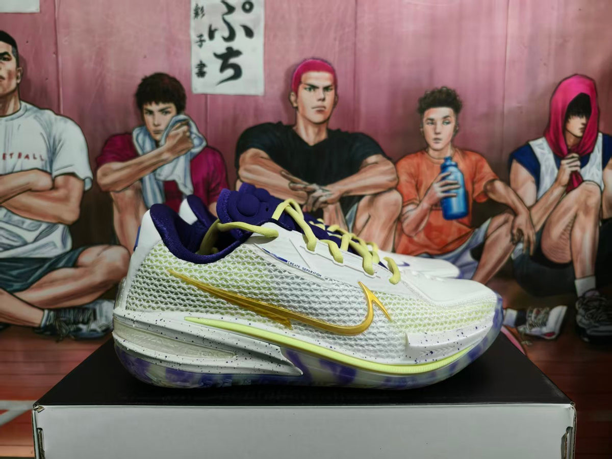 Side view of white Nike basketball sneakers with purple lining, yellow laces, gold Swoosh detailing, and a translucent purple-accented outsole.