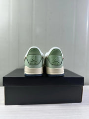 Rear view of the pair showing mint green heel panels, Jordan branding, and dark navy outsoles.