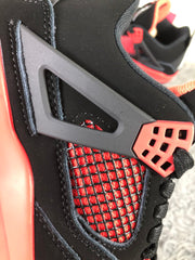Close-up of the red mesh side panel, black cage overlay, and red lace support.