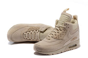 Light beige Nike Air Max 90 Winter sneakerboots shown from front and side angles.