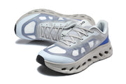 Pair of gray and pale blue lace-up sneakers viewed from above and at an angle.