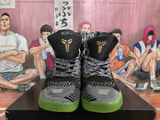 Front view showing black-and-white patterned toe areas, black tongues with gold emblems, and translucent green outsoles.