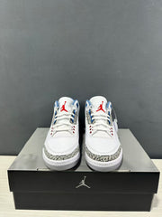 Front view of the sneaker pair showing white perforated toe boxes, red tongue logos, and grey elephant-print toe overlays.