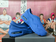Blue Nike Air Max 1000 sneakers arranged at an angle, showing the textured upper, lateral unit, and sculpted outsole.