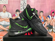 Angled view of the paired black and volt green basketball sneakers, showing the side branding, heel graphics, and rugged outsole.