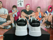 Rear view showing black heel panels with Jordan lettering and white midsoles and outsoles.