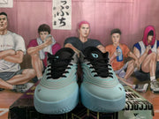 Front view of blue-gray Adidas basketball sneakers with black laces, dark collars, and textured pale aqua toe outsoles.