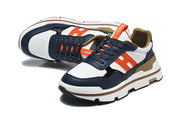 Pair of navy, white, and orange Hermès lace-up sneakers shown from angled top and side views.