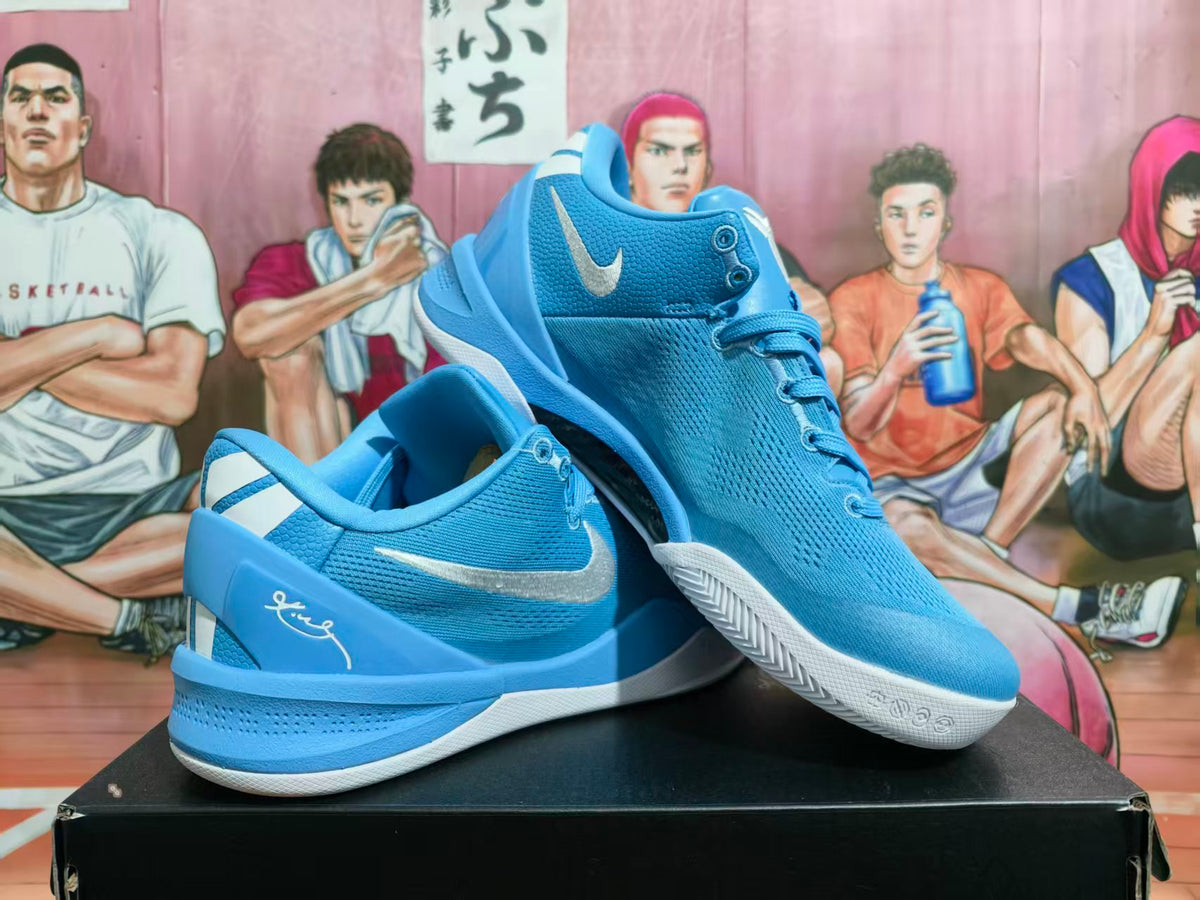 Pair of blue Nike Kobe-style basketball shoes with white accents shown at an angle