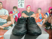 Front view of black lace-up Nike basketball sneakers with rounded toes and textured outsoles.