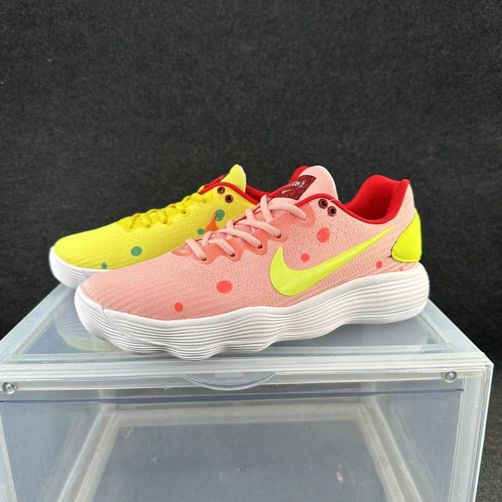 Mismatched pink and yellow low-top sneakers with bright contrasting accents and white textured soles