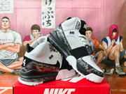 Pair of white and black Nike high-top basketball shoes shown from angled side views.