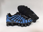 Blue and black Nike Shox-style sneakers shown with the outsole.