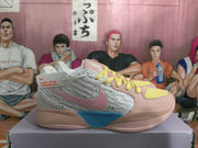 Side view of a multicolor Nike Sabrina 2 basketball shoe with a speckled upper and pink and blue accents.