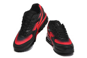Top and front views of a pair of black and red Nike Air Max sneakers.