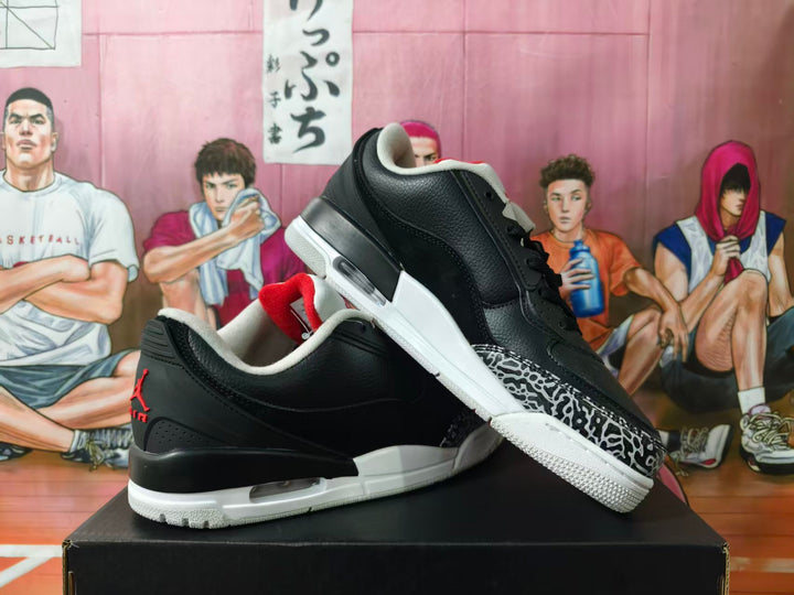 Pair of black and white Jordan-style low-top sneakers with elephant-print toe accents, shown from the side.