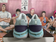 Rear view of the sneakers showing perforated heel panels, purple heel sections, and layered translucent-looking accent details.