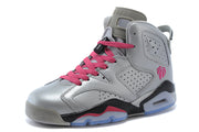 Three-quarter front view of a silver-gray high-top sneaker with pink laces and perforated side panels.