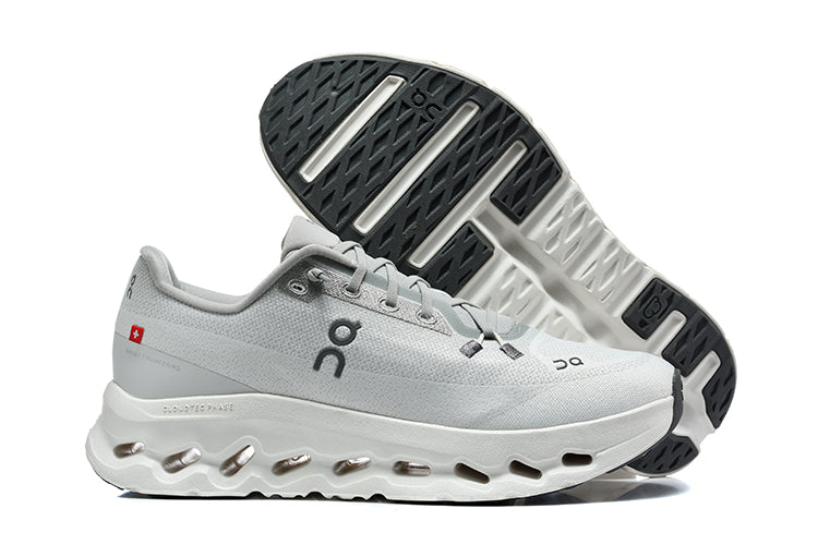 Light gray On running shoe beside a view of its patterned outsole.