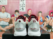 Rear view of the Nike basketball sneakers showing burgundy collars, grey heel panels, and white midsoles.