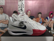 Side view of a white Nike G.T. Cut 3 basketball shoe with black Swoosh and red forefoot accent.