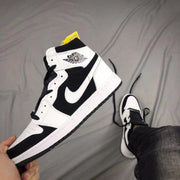 Angled side view displaying the Jordan Wings logo, black side panel, white overlays, and black outsole.