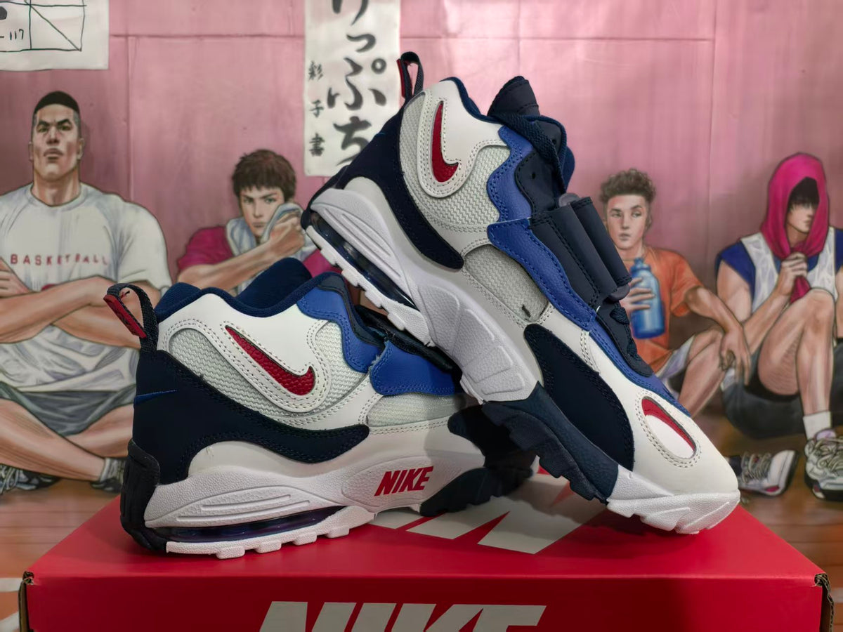 Pair of Nike white, blue, and red strap sneakers displayed on a red Nike shoebox.