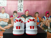 Rear view of white Nike basketball shoes with red heel graphics and outsole accents.
