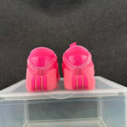 Rear view of the vivid pink sneakers showing padded collars, pull tabs and vertical heel accents.