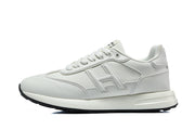 Side profile of a white low-top sneaker with a tonal H-shaped side detail.