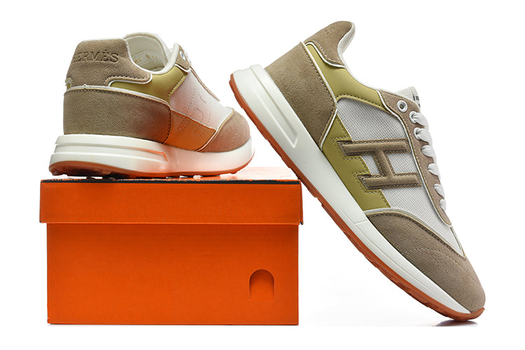 Taupe, white, and olive low-top sneakers displayed beside an orange shoe box