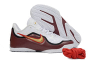 White, black and red Nike LeBron 23 basketball shoe shown beside an outsole view.