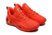 Three-quarter view of the red sneaker pair showing the textured upper and layered sole design.