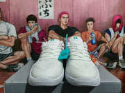 Front view of white Nike basketball shoes with silver and turquoise accents