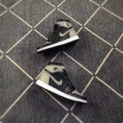 Pair of black and grey high-top sneakers shown from angled side views on a patterned floor.