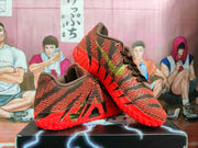 Angled view of the red sneakers showing the lace-up front, textured side panels, black accents, and visible Nike Swoosh.