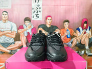 Front view of black sneakers with patterned gray panels