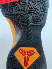 Close-up of the black patterned outsole with orange and red Kobe logo accents.