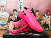 Pink Nike basketball shoes shown from side and outsole angles