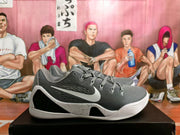 Side view of a gray Kobe basketball shoe with a white logo and speckled midsole