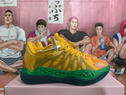 Side view of yellow basketball sneakers with a green midsole and dark patterned outsole