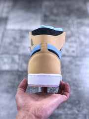 Rear view of the tan and light blue high-top sneaker showing the heel panel, collar, and white outsole.