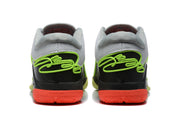 Rear view of the Nike 908-2 sneakers showing black heel panels, green outlining, and coral outsole sections.